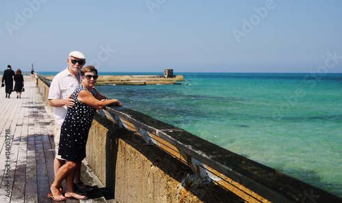 senior couple walking near the sea