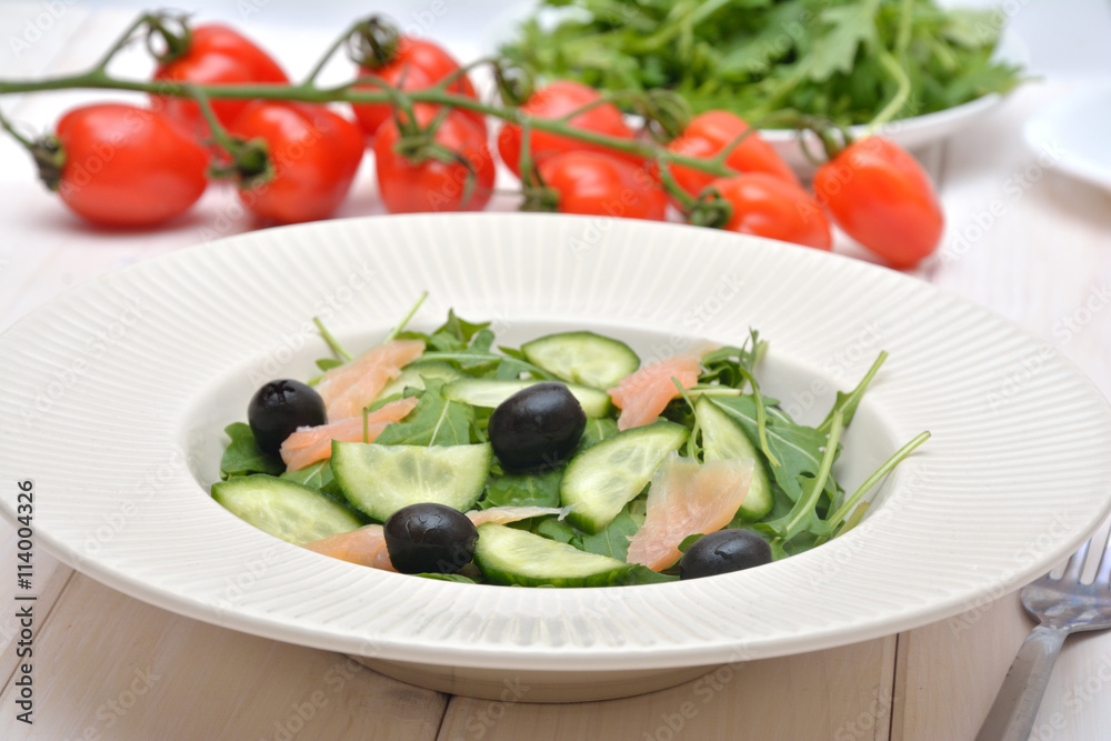 Delicious salad with salmon, olives and cucumber