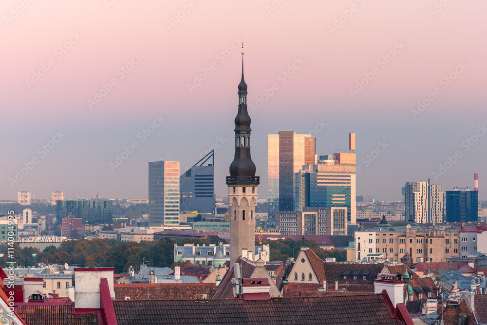 Aerial cityscape with old town hall spire and modern office buildings skyscrapers in the background in the evening, Tallinn, Estonia Aerial cityscape with old town hall spire and modern office buildings skyscrapers in the background in the evening, Tallinn, Estonia