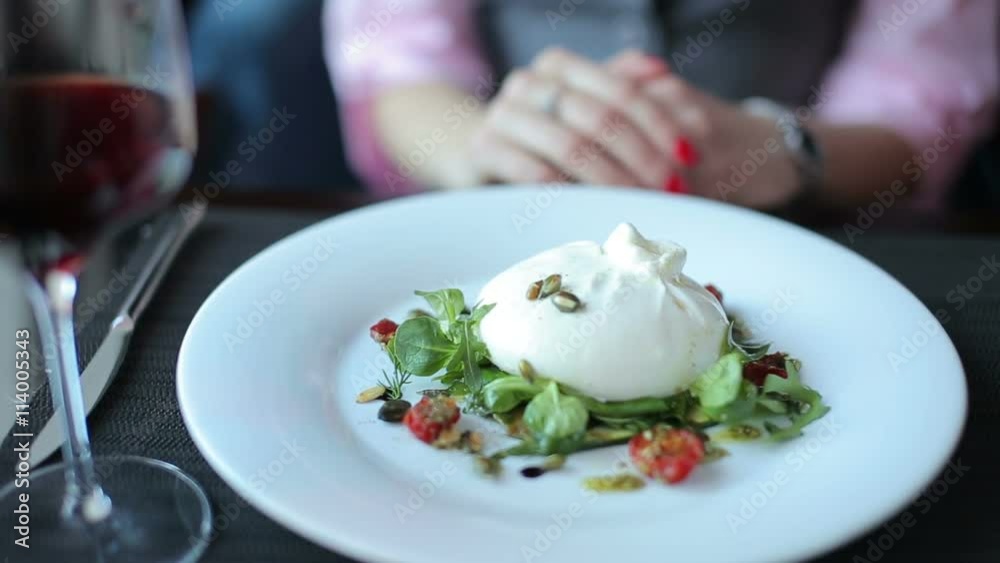 Burrata cheese served with red wine to client Burrata cheese served with red wine to client