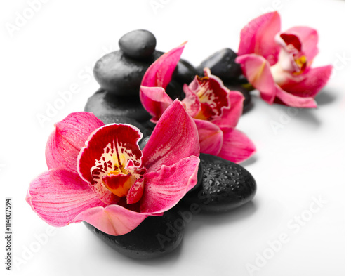 Fototapeta Naklejka Na Ścianę i Meble -  Spa stones and red orchid isolated on white