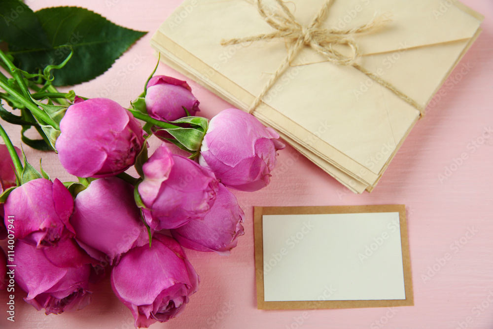 Fresh roses and present on wooden background Fresh roses and present on wooden background