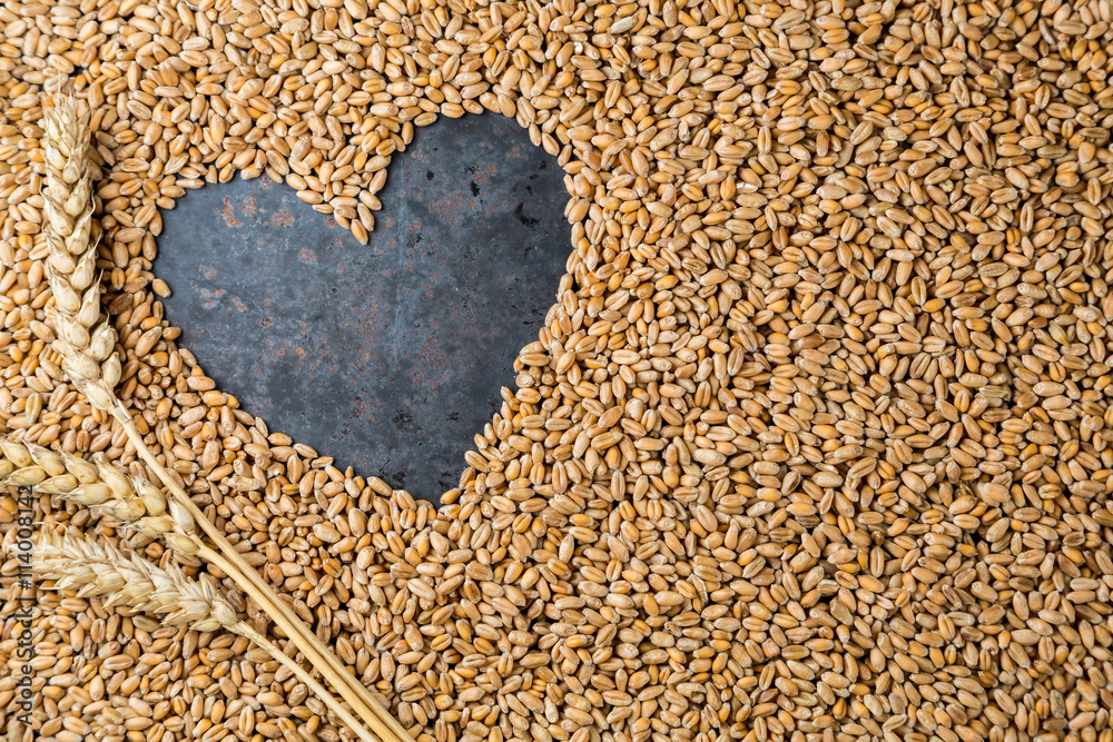 Grey metal heart from seeds of ripe golden wheat Grey metal heart from seeds of ripe golden wheat