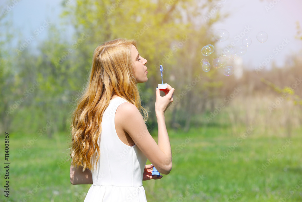 Young beautiful woman with bubbles on meadow Young beautiful woman with bubbles on meadow