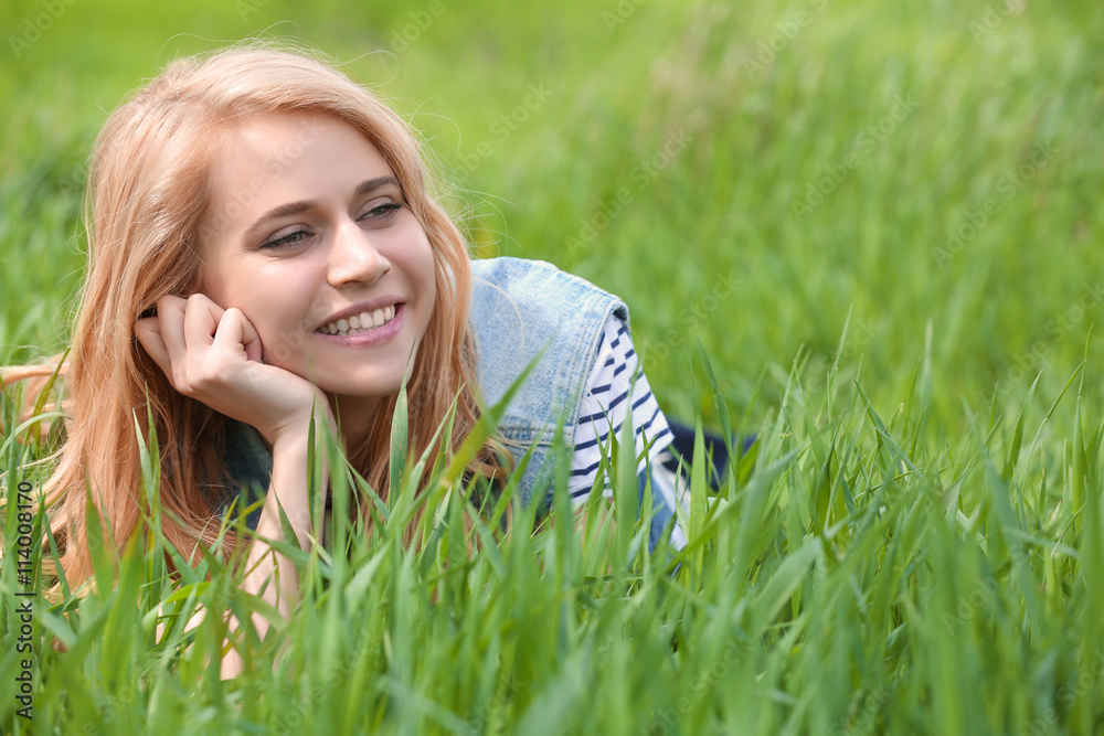 Young beautiful woman on green grass Young beautiful woman on green grass
