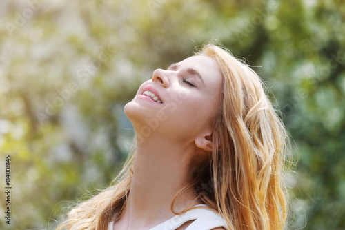 Young beautiful woman on blooming tree background