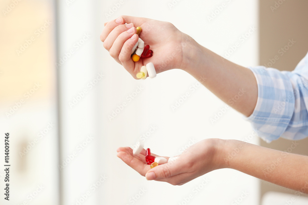 Woman taking vitamins, closeup