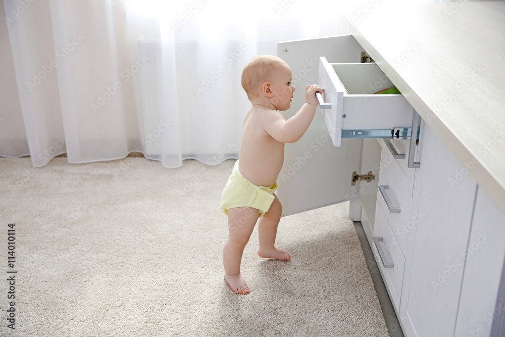 Baby boy playing with locker in the room Baby boy playing with locker in the room