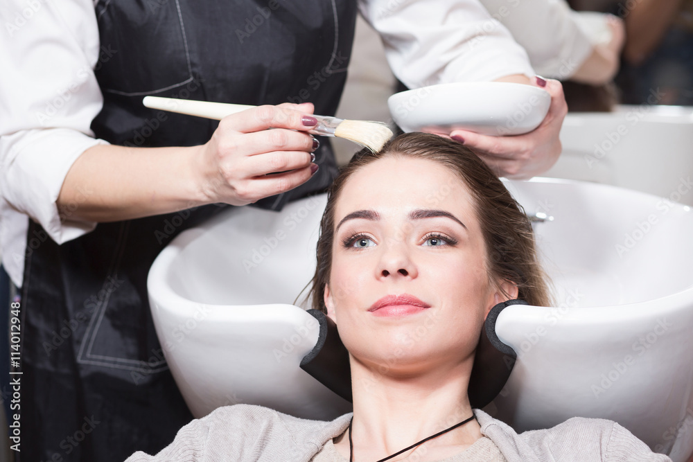 Φωτογραφία Beautiful lady having her hair washed by hairdresser in hairdressing saloon