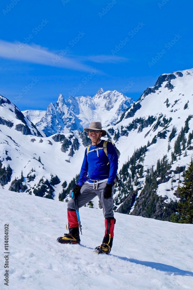 Man climber on snow covered mounain top. Mount Shuksan, North Cascades National Park, Washington state, USA. 