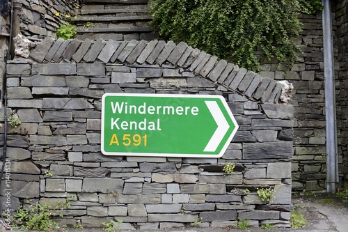 A UK road sign, showing direction to Windermere and Kendal