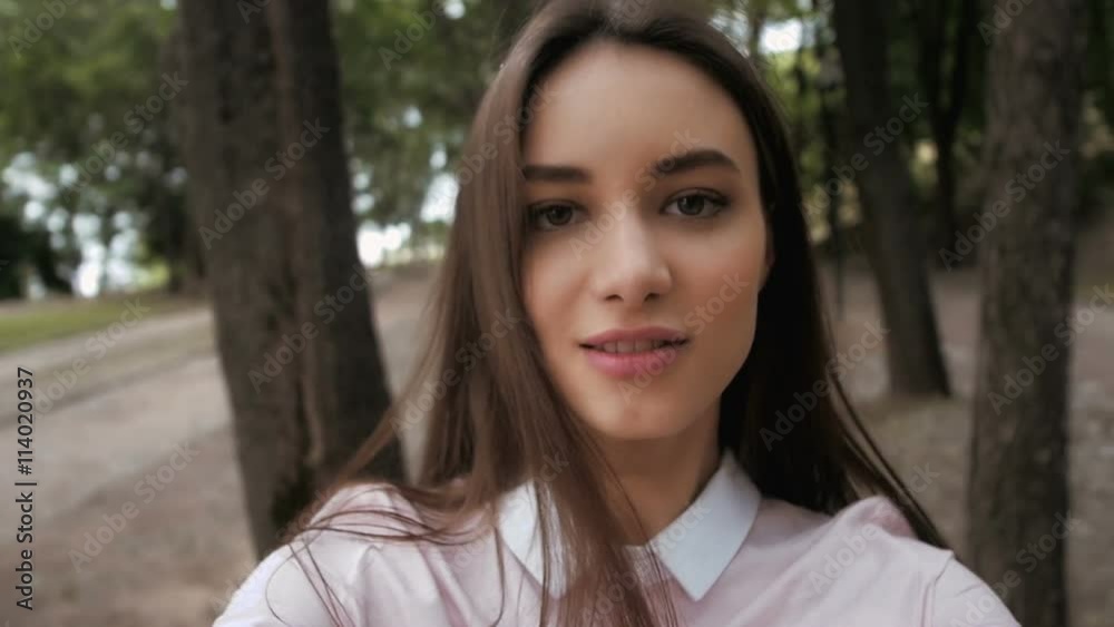 Follow me girl concept. Young pretty happy student model smiling and walking in park. Follow me girl concept. Young pretty happy student model smiling and walking in park.