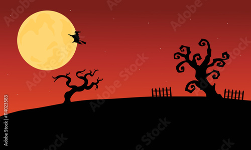 Halloween witch flying and dry tree silhouette