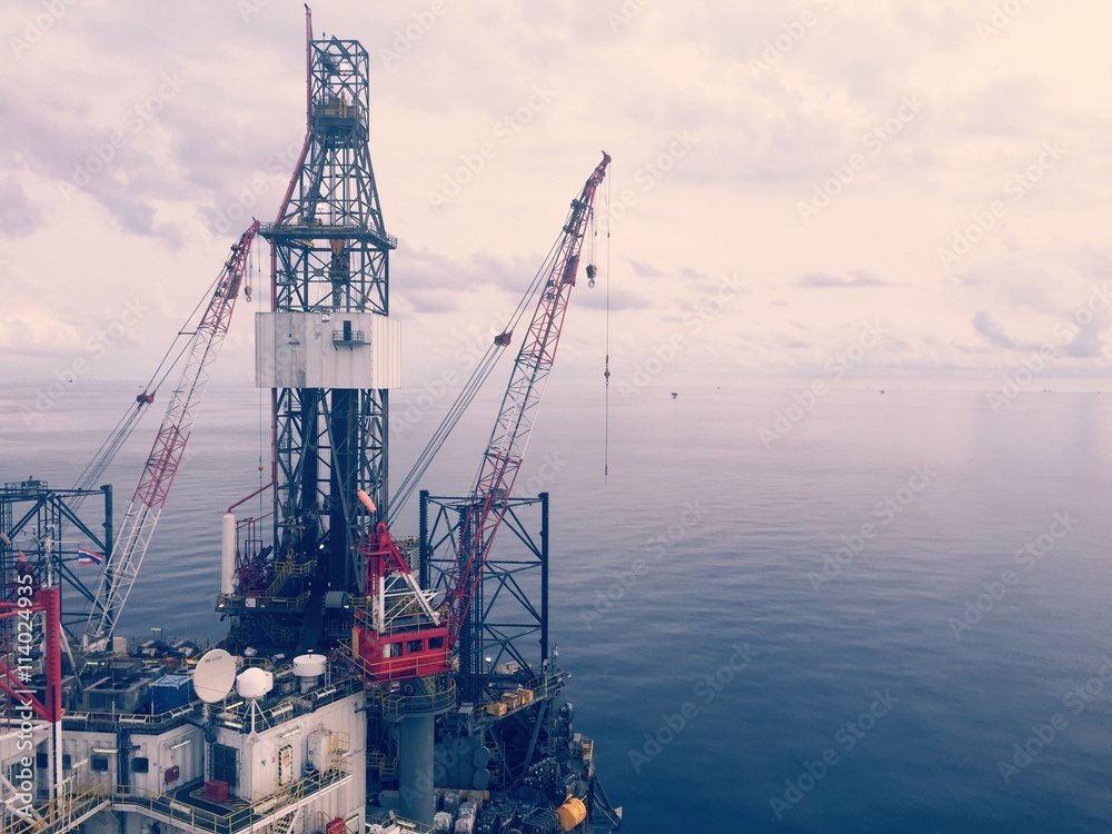 Offshore jack up rig in the gulf with cloudy day, Process colour with vintage style. Offshore jack up rig in the gulf with cloudy day, Process colour with vintage style.