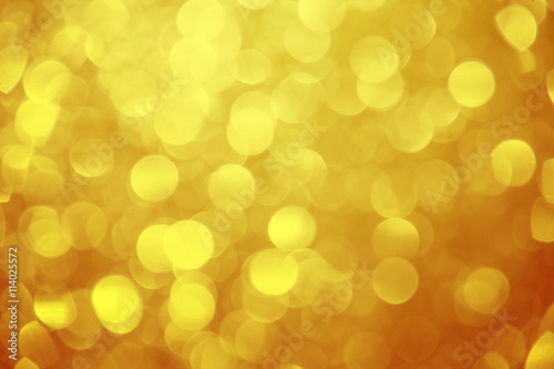 Gold glitter sparkle defocused rays lights bokeh beautiful abstract background.