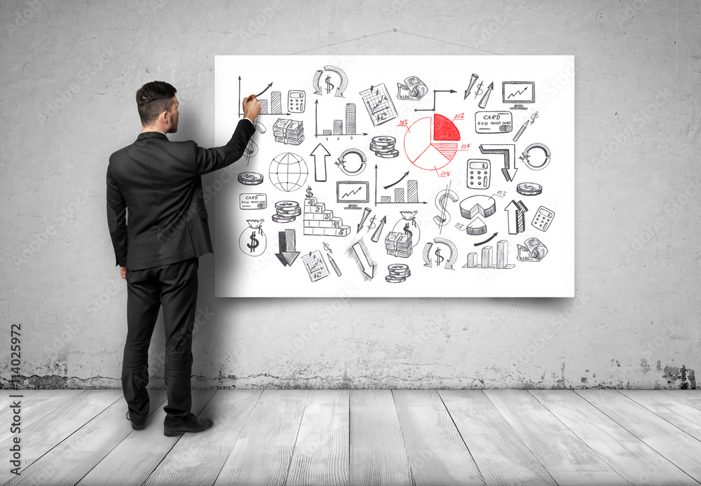 Back view of businessman drawing economic graphics on white canvas. Back view of businessman drawing economic graphics on white canvas.