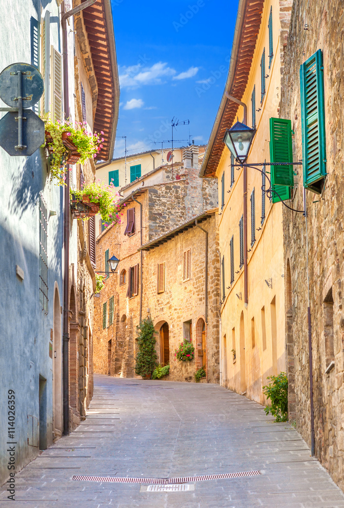 Montepulciano, Italy. Old narrow street in the center of town with colorful facades.