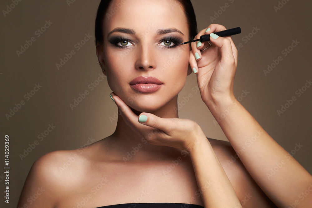 Makeup artist applies eye shadow. Beautiful woman face. beauty girl with Perfect make-up Makeup artist applies eye shadow. Beautiful woman face. beauty girl with Perfect make-up
