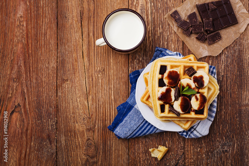 Delicious waffles with banana and chocolate