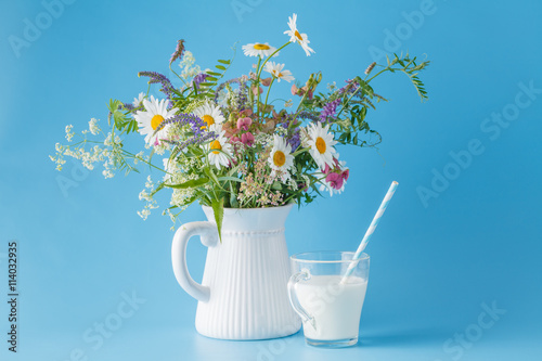 Summer breakfast with milk and wildflowers