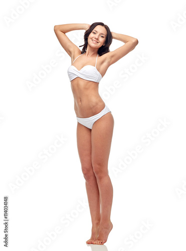 happy young woman in white bikini swimsuit