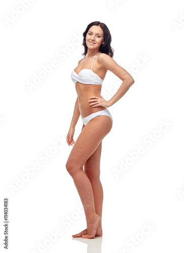 happy young woman in white bikini swimsuit
