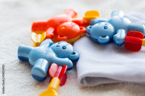 close up of baby rattle and clothes for newborn