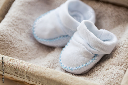 close up of baby bootees for newborn boy in basket