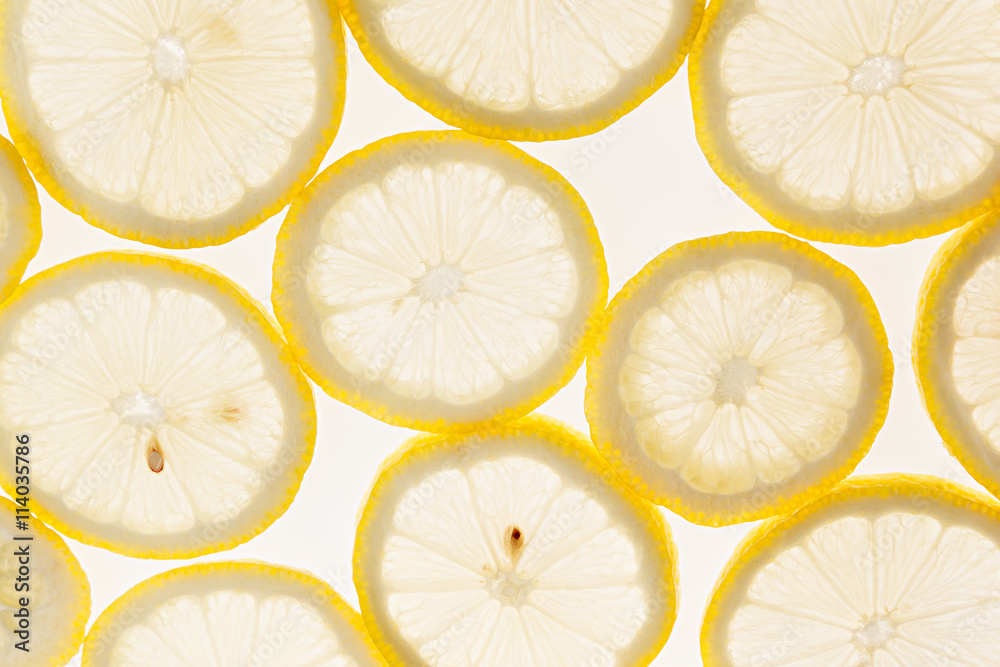 Slices of lemon on a white background. Pattern. Macro. Fruit background. Slices of lemon on a white background. Pattern. Macro. Fruit background.