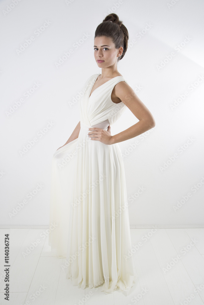 Studio Shot Of Sensual Elegant Woman With Classic Hairstyle Posing In Beautiful White Dress Against White Background Studio Shot Of Sensual Elegant Woman With Classic Hairstyle Posing In Beautiful White Dress Against White Background