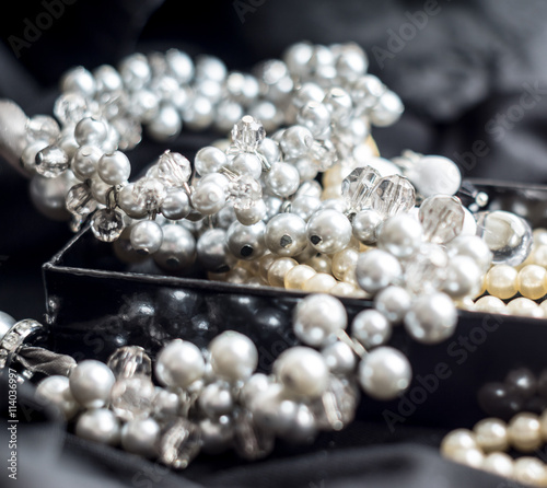Pearl necklace with blurred background on black