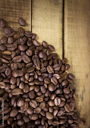 Coffee beans on grunge wooden background © orijinal_x