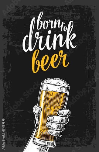 Male hand holding a beer glass.