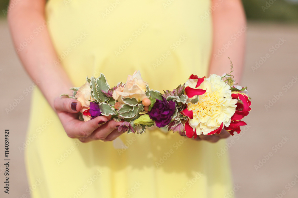 hands holding a wreath