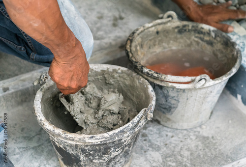 cement portland gray fresh mortar mix with spatula tool in bucket 