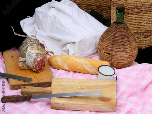 picinc with salami, fragrant bread and big knife photo