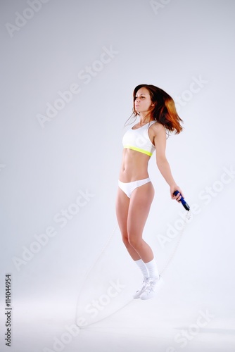 Young active woman with jump rope in studio © dojo666