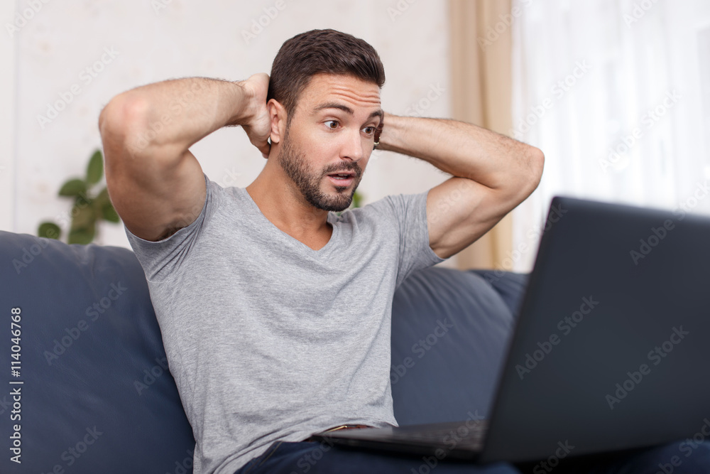 Man read bad news on laptop Man read bad news on laptop