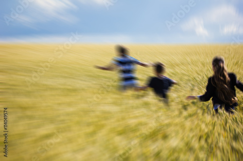 kids on field running blurred.
