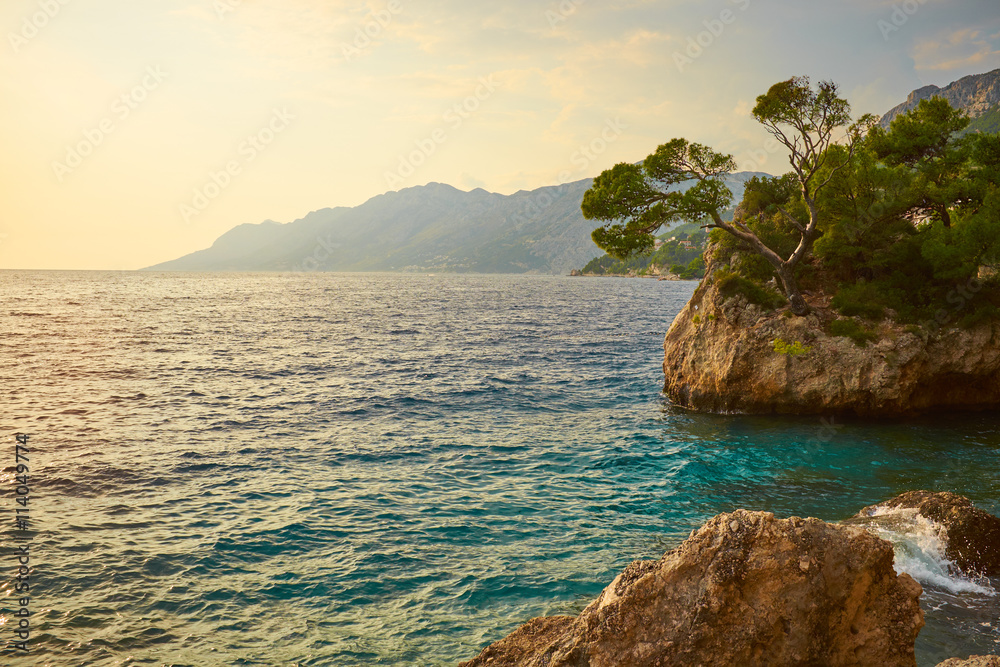 Obraz premium Rock island at sunset in small mediterranean town Brela , Croati