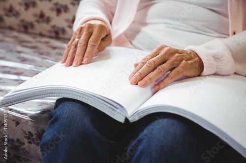 Senior woman using braille to read