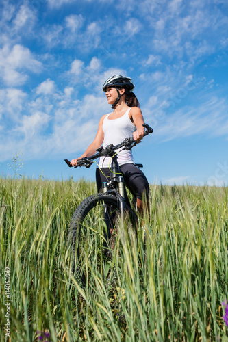 girl rides a bicycle in the countryside