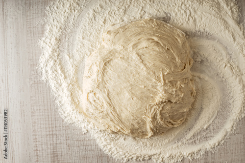 Dough on the table with flour top view