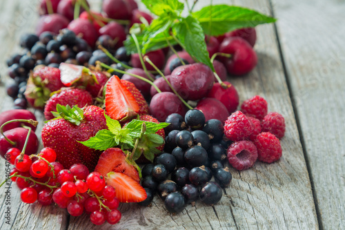 Selection of colorful berries on rustic background