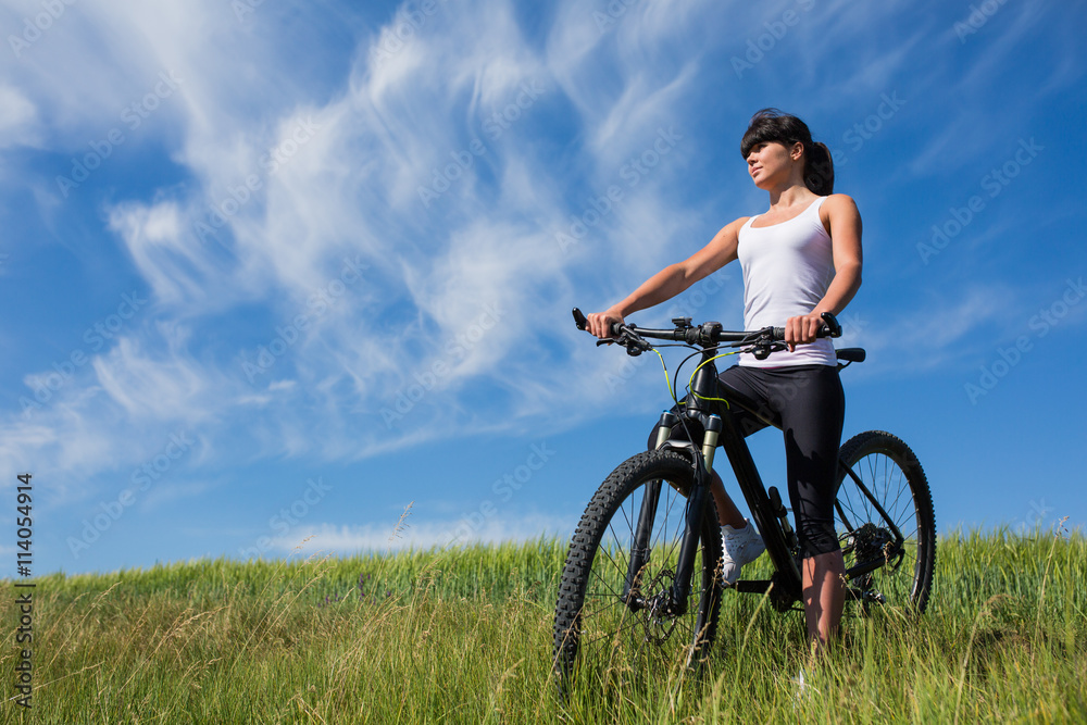 Mountain biking happy sportive girl relax in meadows sunny countryside