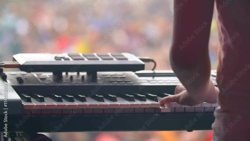 man with synthesizer plays music on the concert