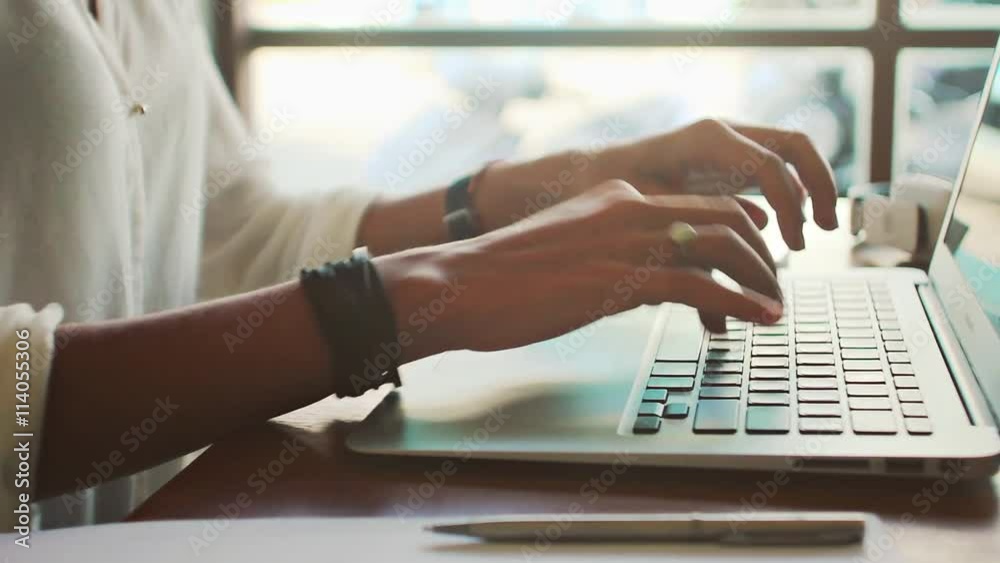 Young woman freelancer typing on laptop