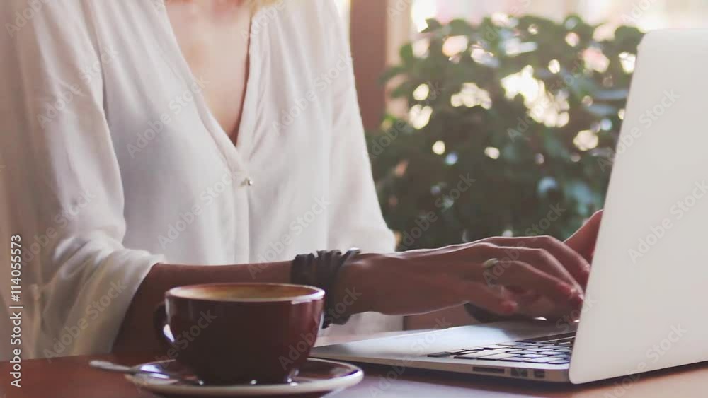 Young woman freelancer typing on laptop