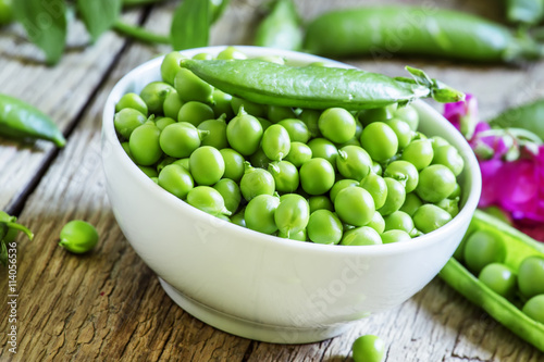 Grains and pods of green peas, vintage wooden background, select