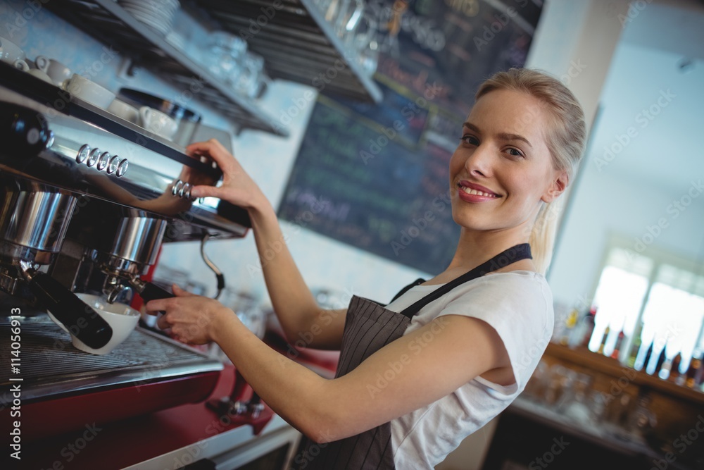 Portrait of happy barista using espresso maker at cafe Portrait of happy barista using espresso maker at cafe